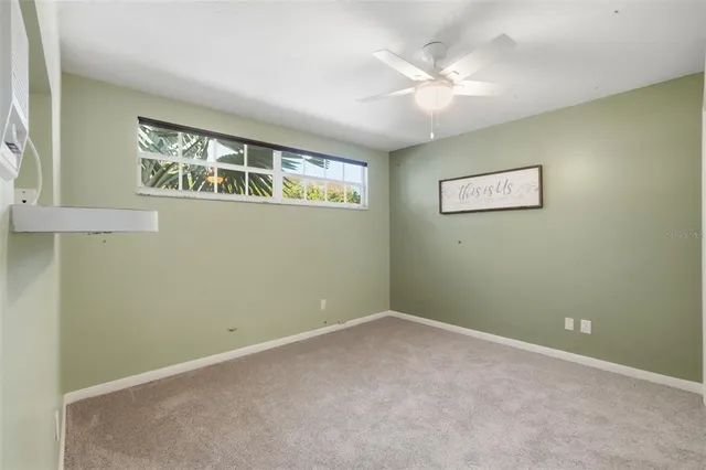a view of a room with furniture and a window