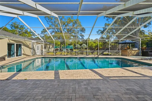 a view of a patio with chairs under an umbrella