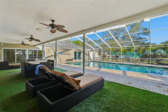 a view of a backyard with sitting area and tub
