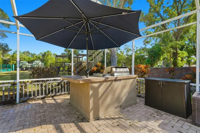 a view of a chairs and table in patio with a small yard