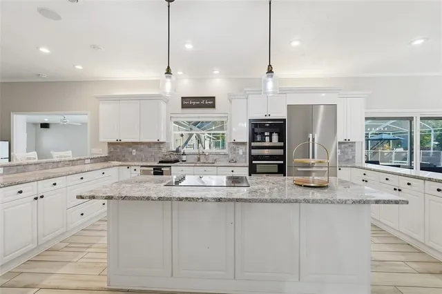 a kitchen with stainless steel appliances a refrigerator sink and cabinets