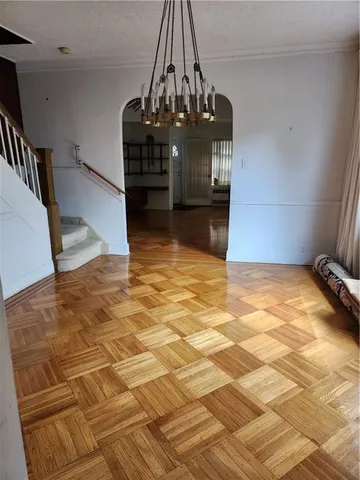 a view of a livingroom with wooden floor and staircase