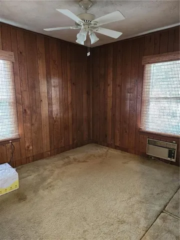 an empty room with a window and a chandelier