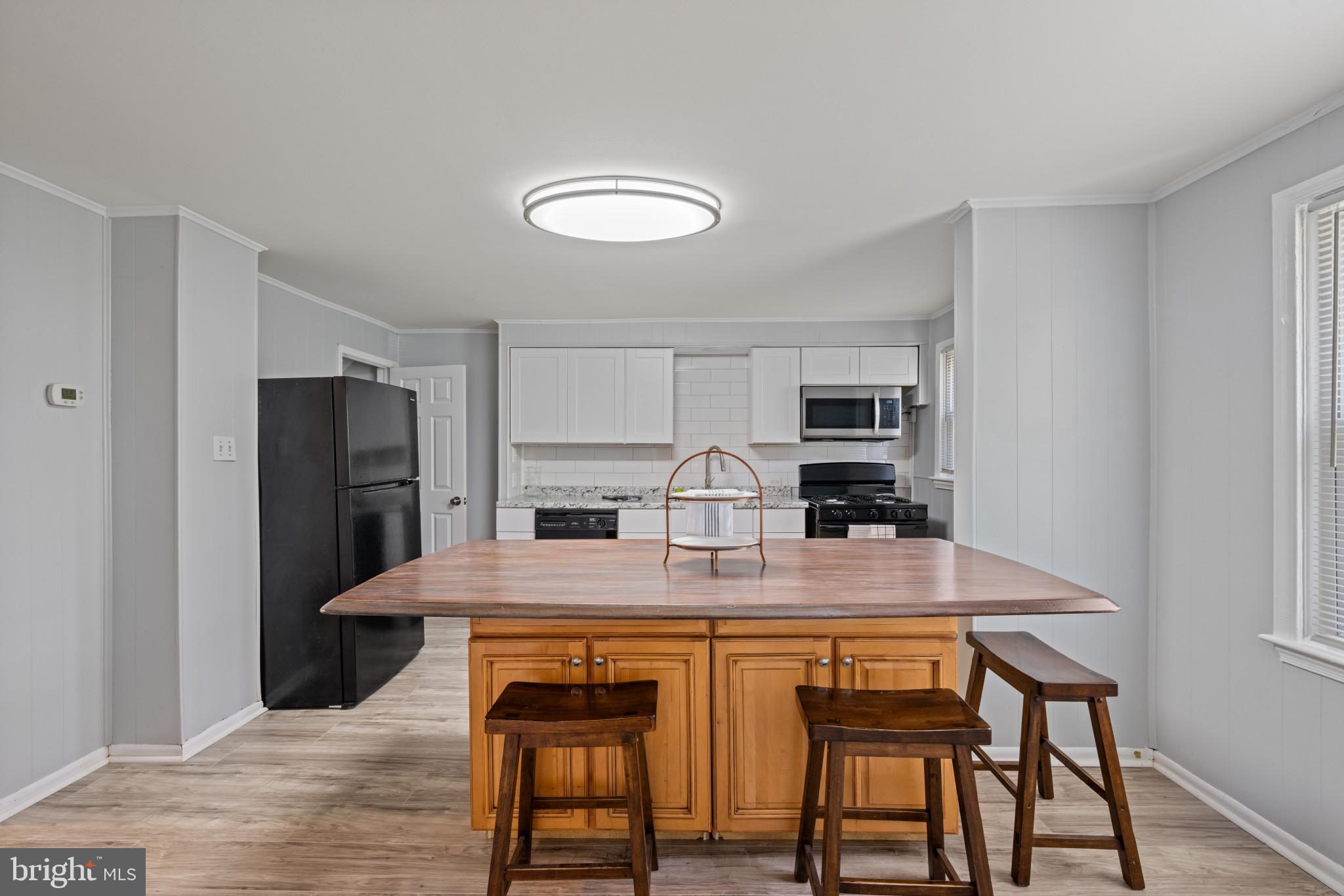 301 3rd Street Baltimore, MD 21206 - Photo 11 of 25 a view of a dining room with furniture