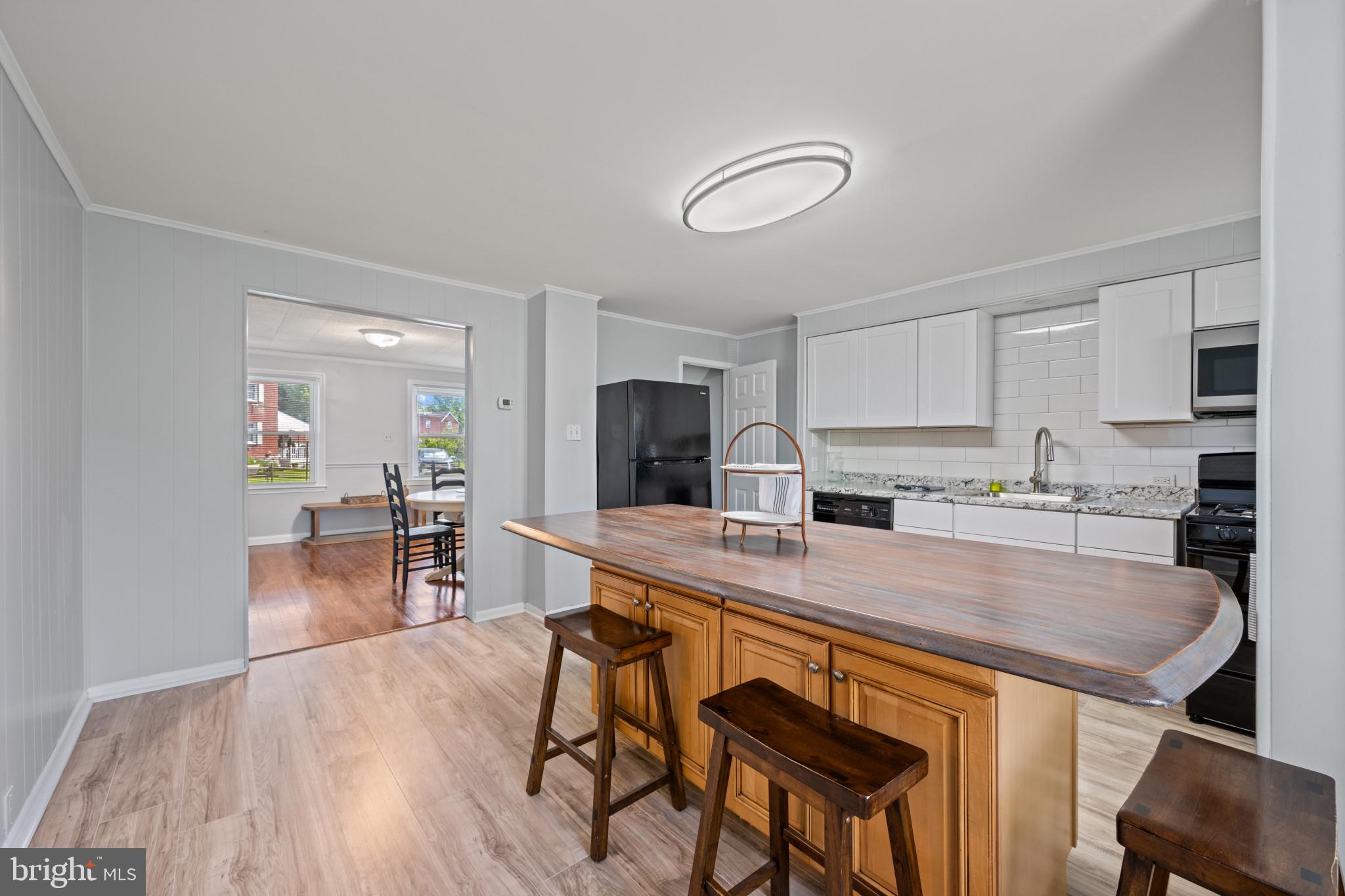 301 3rd Street Baltimore, MD 21206 - Photo 12 of 25 a large kitchen with a table and chairs in it