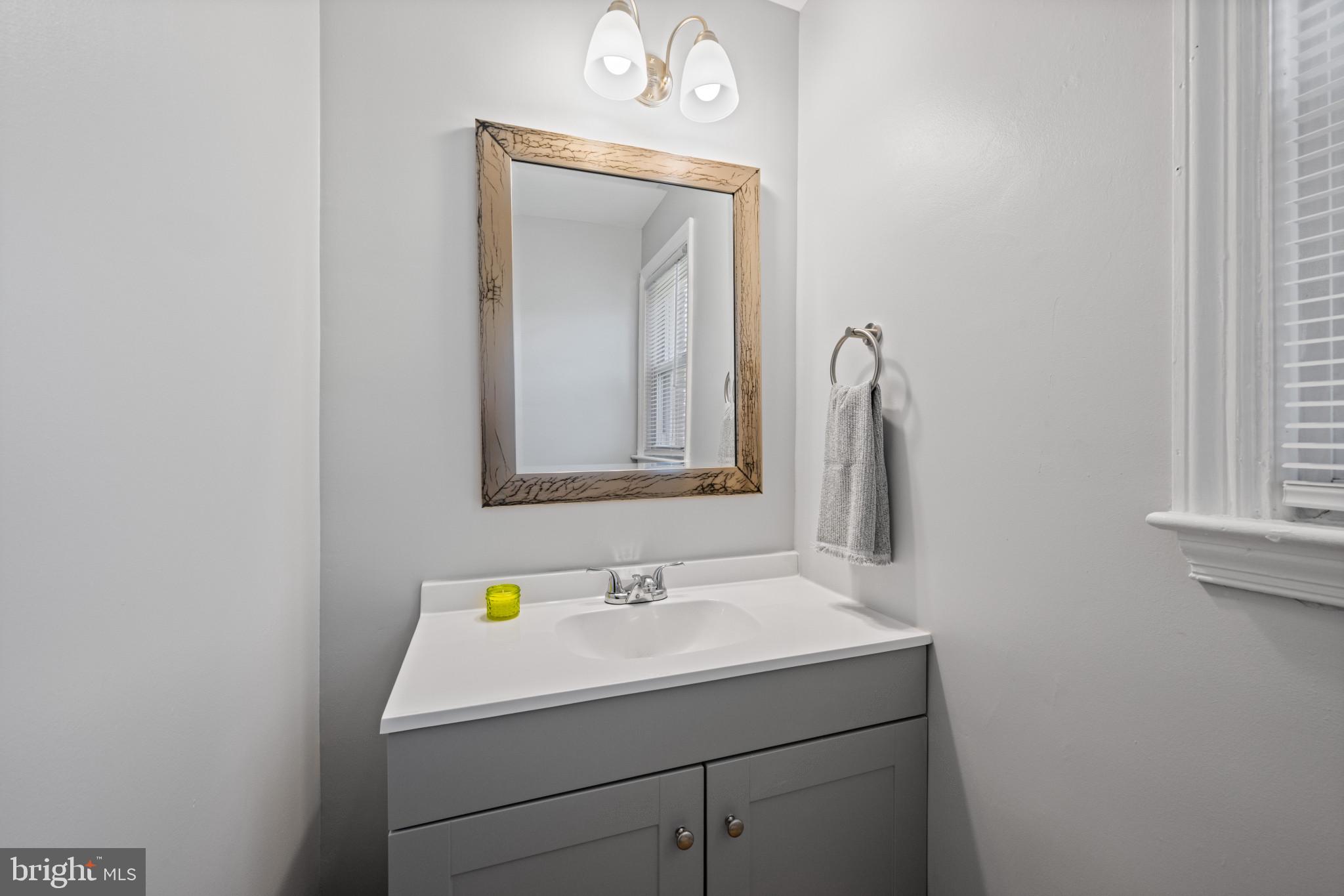 301 3rd Street Baltimore, MD 21206 - Photo 18 of 25 a bathroom with a sink and a mirror