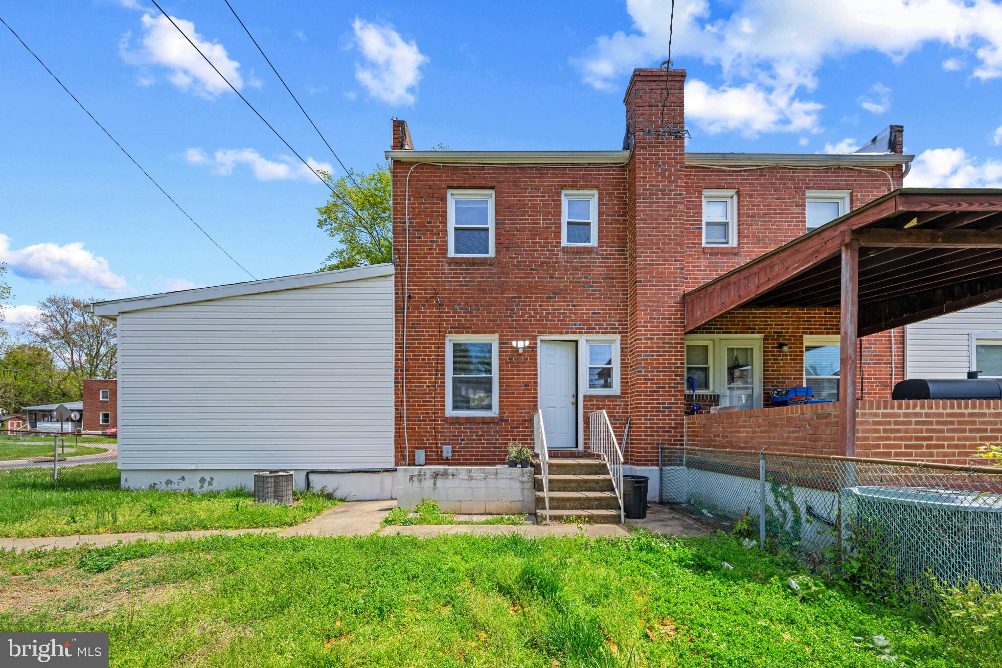 301 3rd Street Baltimore, MD 21206 - Photo 23 of 25 a front view of a house with a yard and a table