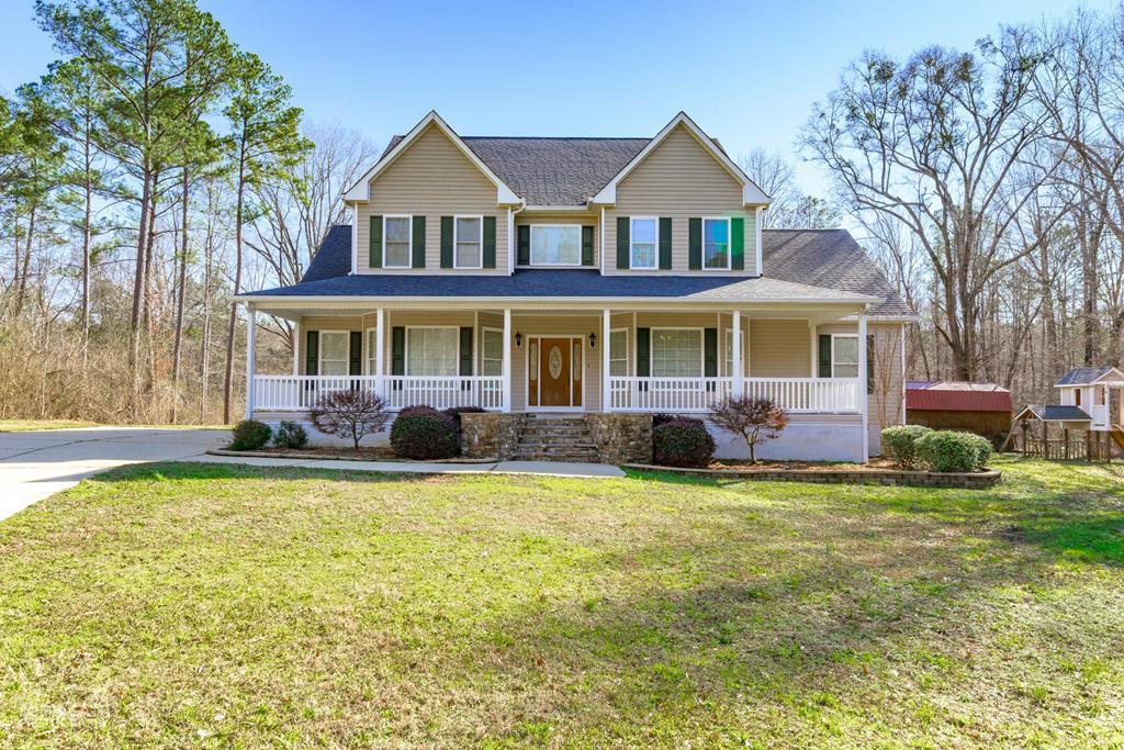 905 Blue Store Road Forsyth, GA 31029 - Photo 1 of 30 a front view of a house with a garden and trees