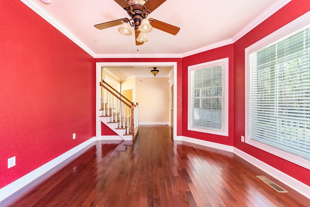 905 Blue Store Road Forsyth, GA 31029 - Photo 3 of 30 a view of a livingroom with wooden floor and a ceiling fan