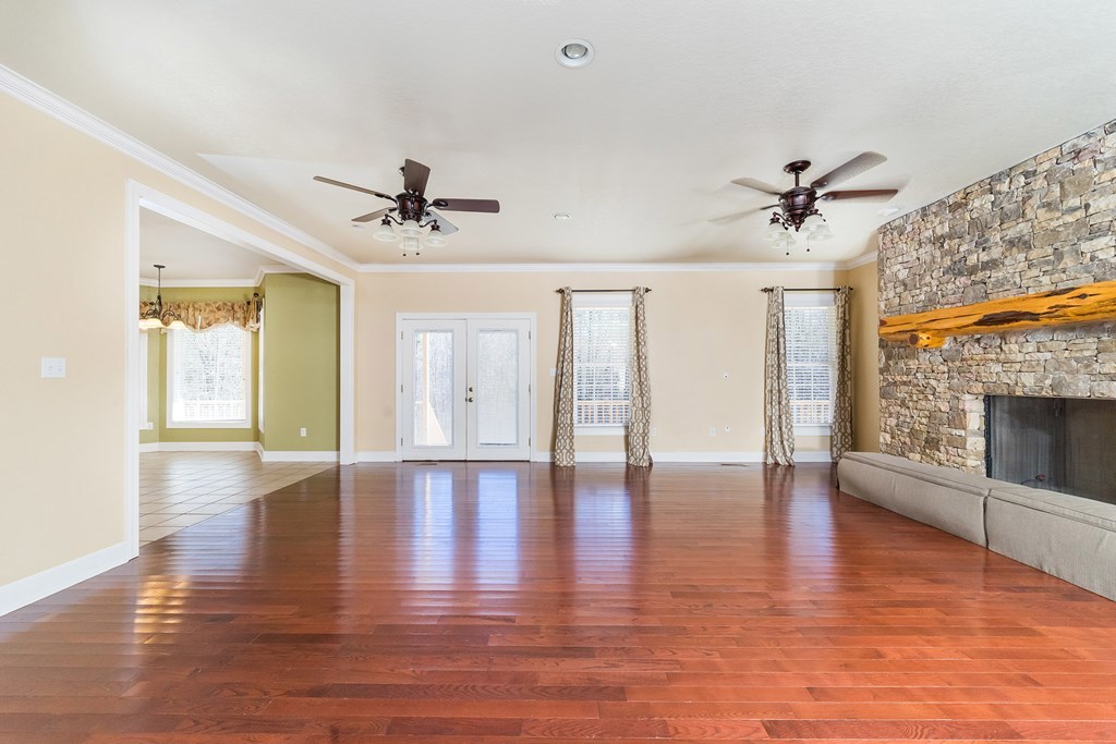 905 Blue Store Road Forsyth, GA 31029 - Photo 4 of 30 a view of an empty room with a fireplace and wooden floor