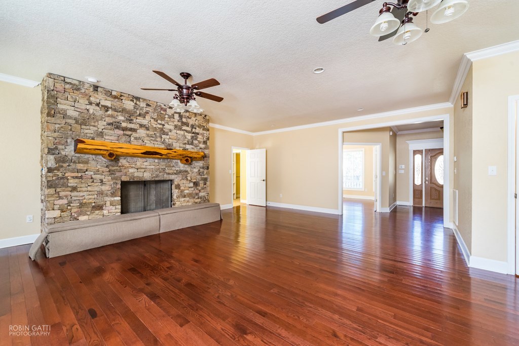 905 Blue Store Road Forsyth, GA 31029 - Photo 5 of 30 a view of a livingroom with wooden floor and a fireplace