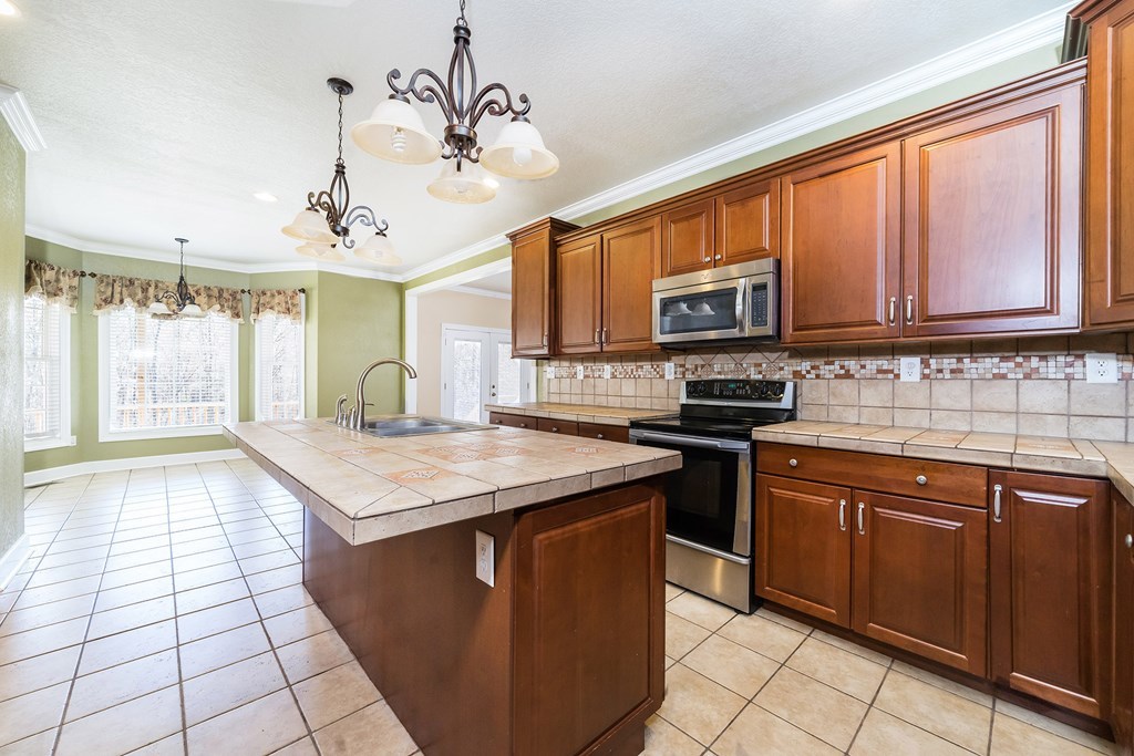 905 Blue Store Road Forsyth, GA 31029 - Photo 7 of 30 a kitchen with a stove sink and microwave
