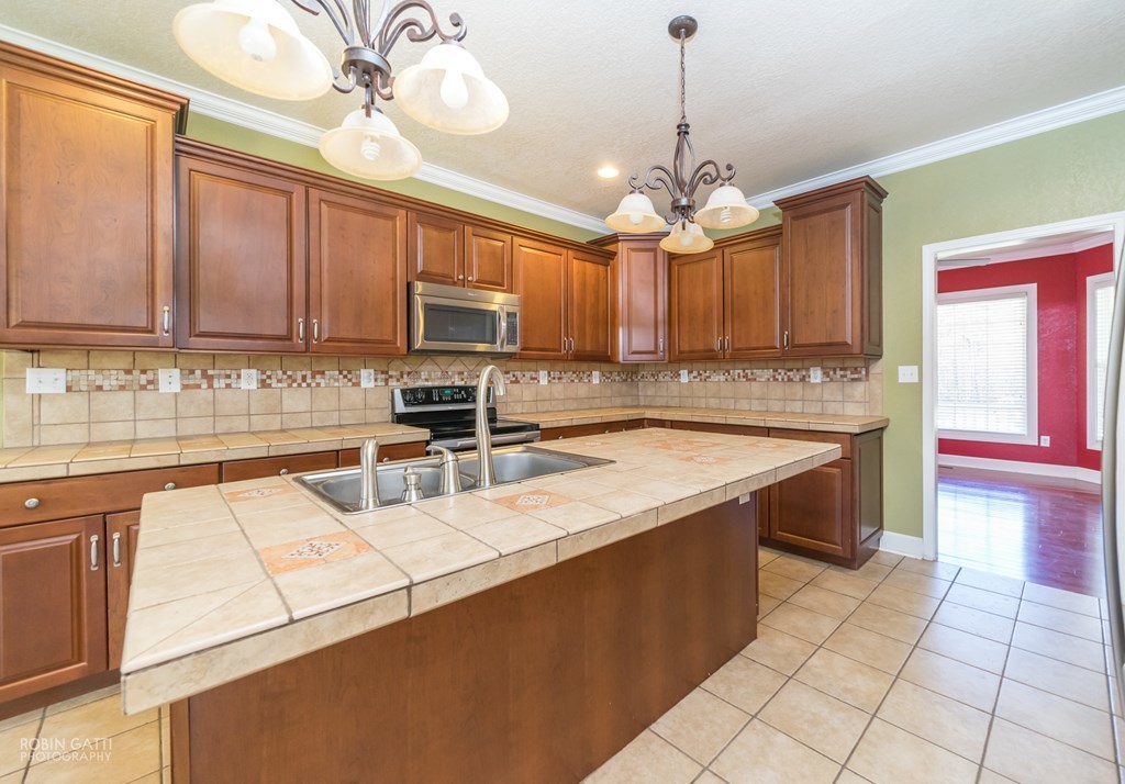 905 Blue Store Road Forsyth, GA 31029 - Photo 8 of 30 a kitchen with stainless steel appliances granite countertop a sink a stove top oven a counter space and cabinets