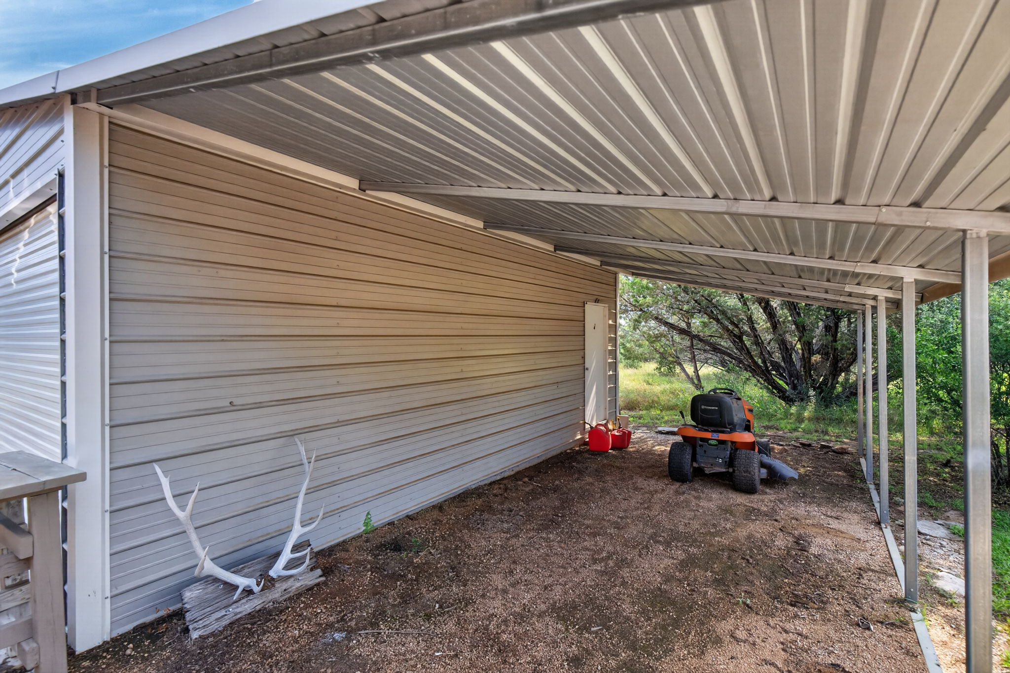 207 Deer Ridge Drive Burnet, TX 78611 - Photo 12 of 36 A robust metal carport provides practical covered parking and outdoor storage.