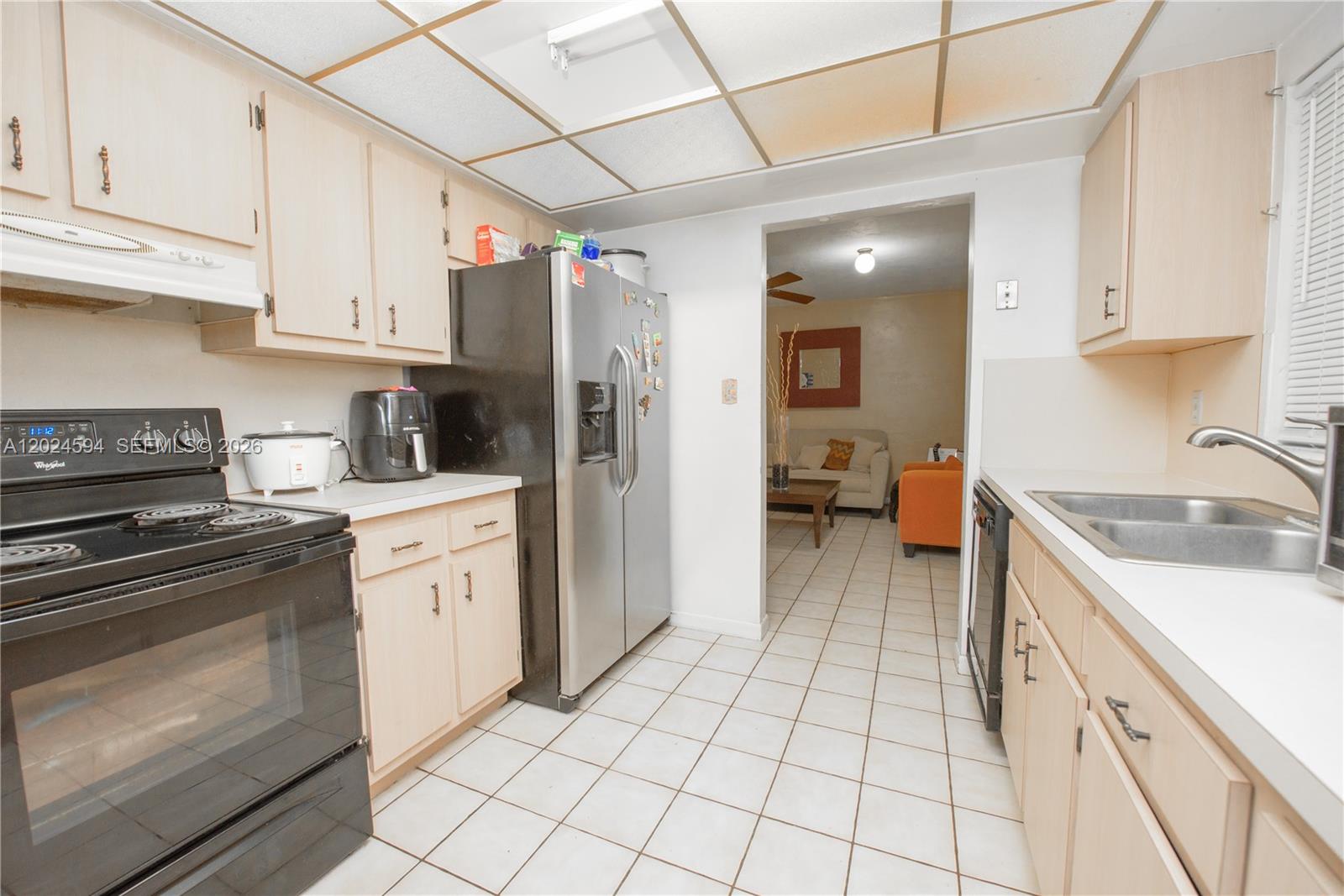 17355 Southwest 256th Street Homestead, FL 33031 - Photo 11 of 32 a kitchen with stainless steel appliances granite countertop a stove a sink and a refrigerator