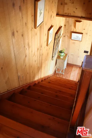 a bedroom with a bed and a mirror