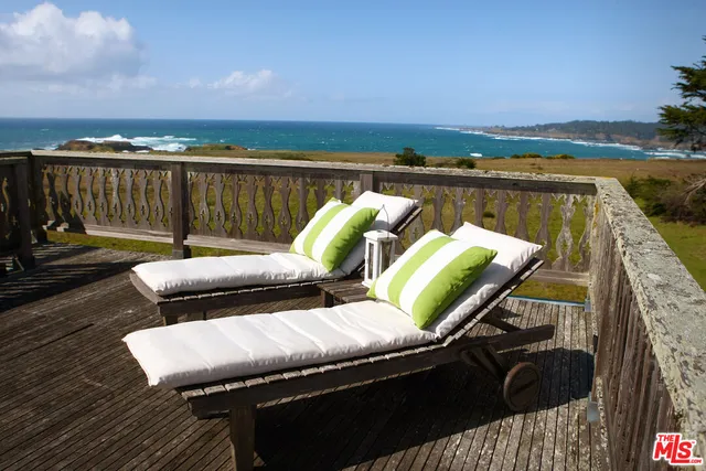 a view of a field with an ocean