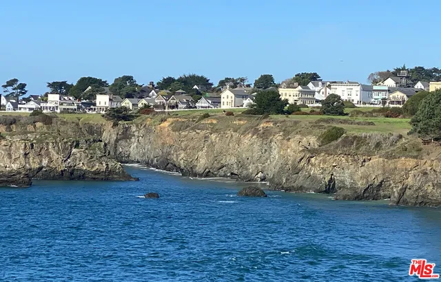 a car parked in front of a white house