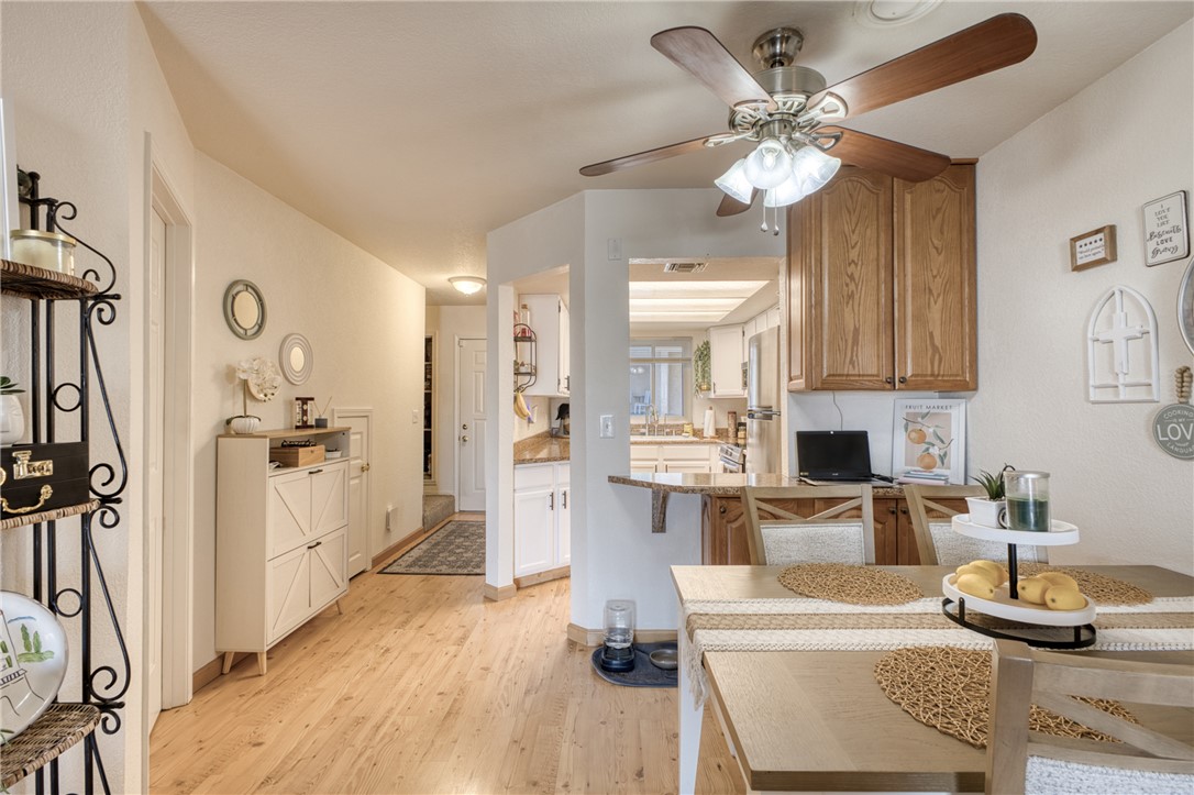 3400 Sunriver Road, Unit D2 Bullhead City, AZ 86429 - Photo 10 of 61 Dining area with wood-look flooring and a ceiling fan with light fixture