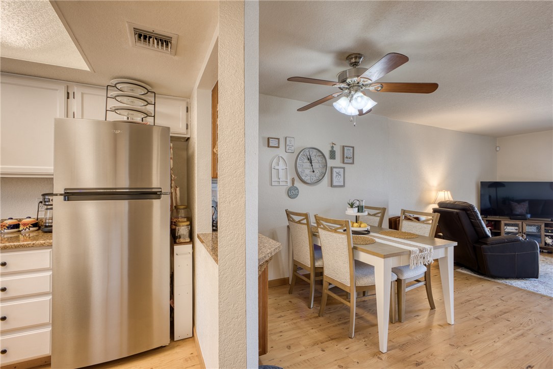 3400 Sunriver Road, Unit D2 Bullhead City, AZ 86429 - Photo 16 of 61 The kitchen features a stainless steel refrigerator, white cabinetry, and granite countertops