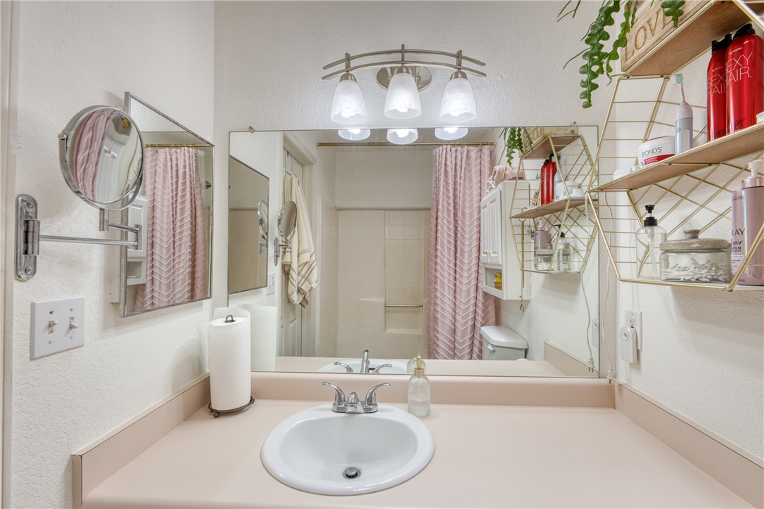 3400 Sunriver Road, Unit D2 Bullhead City, AZ 86429 - Photo 23 of 61 Bathroom vanity with an integrated sink, a large wall mirror, and overhead lighting