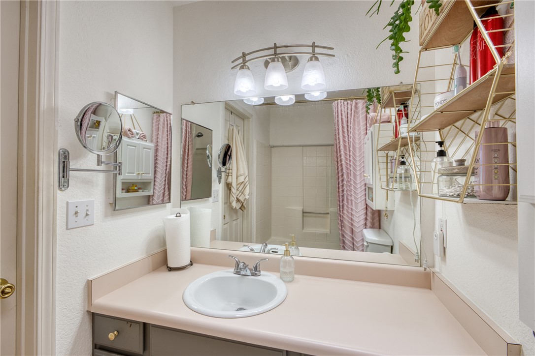 3400 Sunriver Road, Unit D2 Bullhead City, AZ 86429 - Photo 25 of 61 The bathroom features a vanity with an integrated sink, a large wall-mounted mirror, and overhead lighting