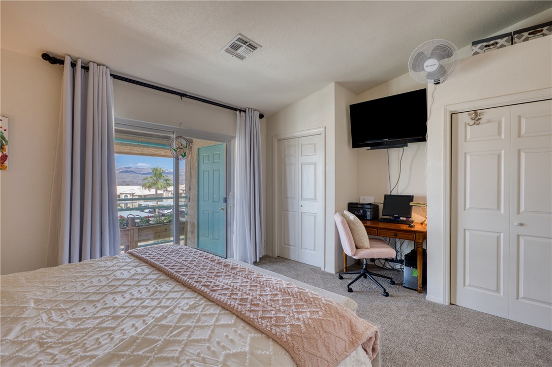 3400 Sunriver Road, Unit D2 Bullhead City, AZ 86429 - Photo 26 of 61 This room features light-colored walls and carpeting, offering a bright and neutral palette
