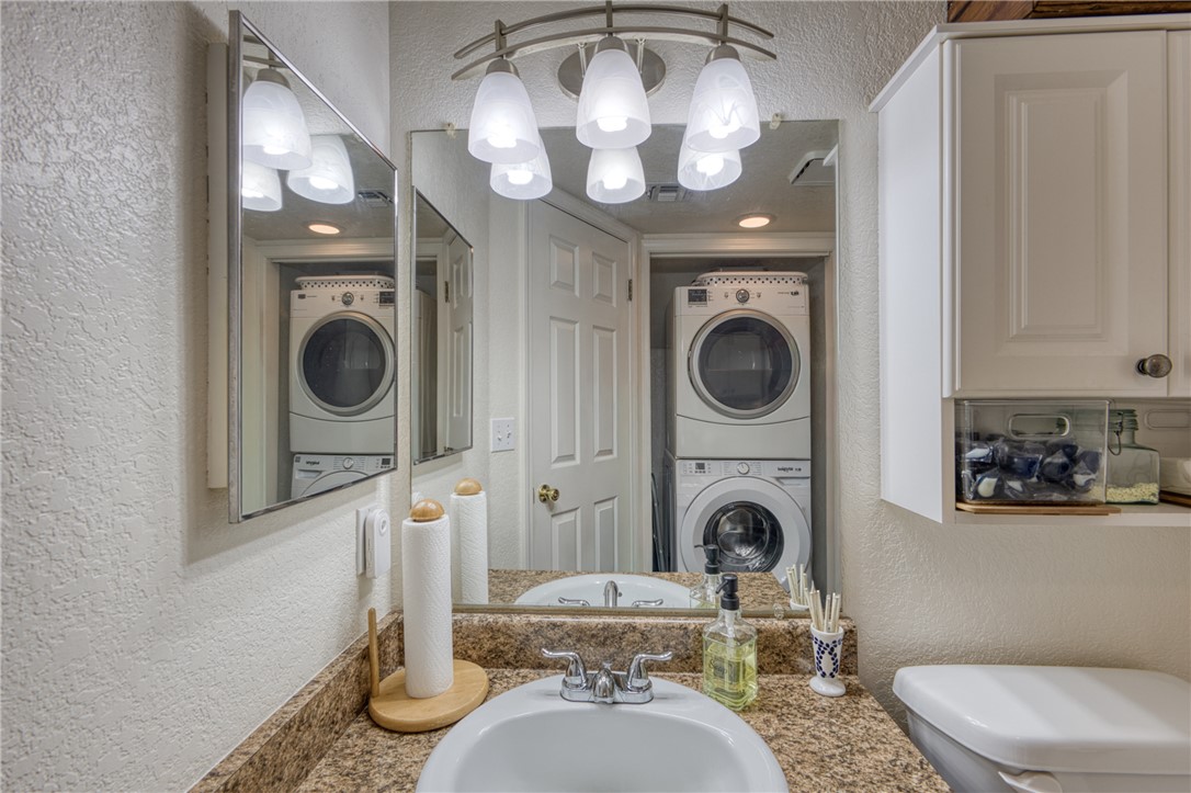 3400 Sunriver Road, Unit D2 Bullhead City, AZ 86429 - Photo 31 of 61 Bathroom featuring a vanity with a light-colored countertop, a sink with a chrome faucet, and a wall-mounted mirror