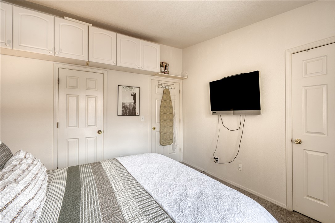 3400 Sunriver Road, Unit D2 Bullhead City, AZ 86429 - Photo 34 of 61 This space features white walls, overhead cabinetry, and two white paneled doors