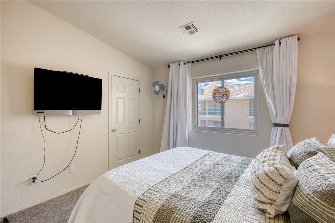 3400 Sunriver Road, Unit D2 Bullhead City, AZ 86429 - Photo 35 of 61 This room features neutral walls, carpeted floors, and a window with white curtains