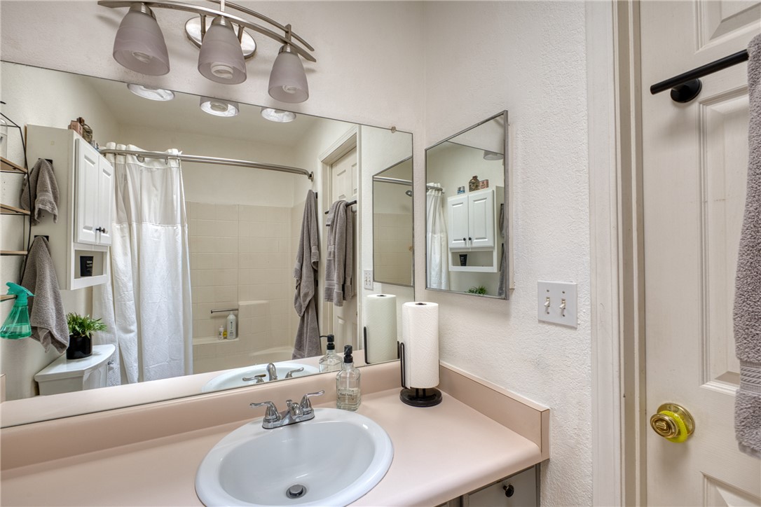 3400 Sunriver Road, Unit D2 Bullhead City, AZ 86429 - Photo 40 of 61 Bathroom featuring a vanity with an integrated sink, a large wall-mounted mirror, and a light fixture with three frosted glass shades