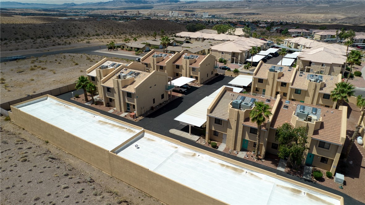 3400 Sunriver Road, Unit D2 Bullhead City, AZ 86429 - Photo 49 of 61 Aerial view showcasing the property's stucco exterior, tile roofs, and covered parking spaces