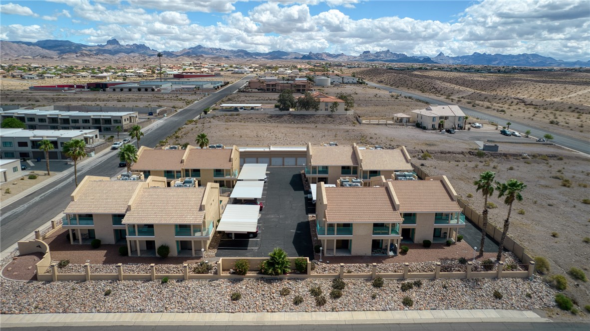3400 Sunriver Road, Unit D2 Bullhead City, AZ 86429 - Photo 51 of 61 This property features a series of buildings with uniform design, each offering balconies with clear railings