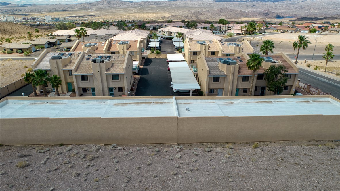 3400 Sunriver Road, Unit D2 Bullhead City, AZ 86429 - Photo 58 of 61 Aerial view of the property, featuring a cluster of buildings with flat roofs and a desert landscape