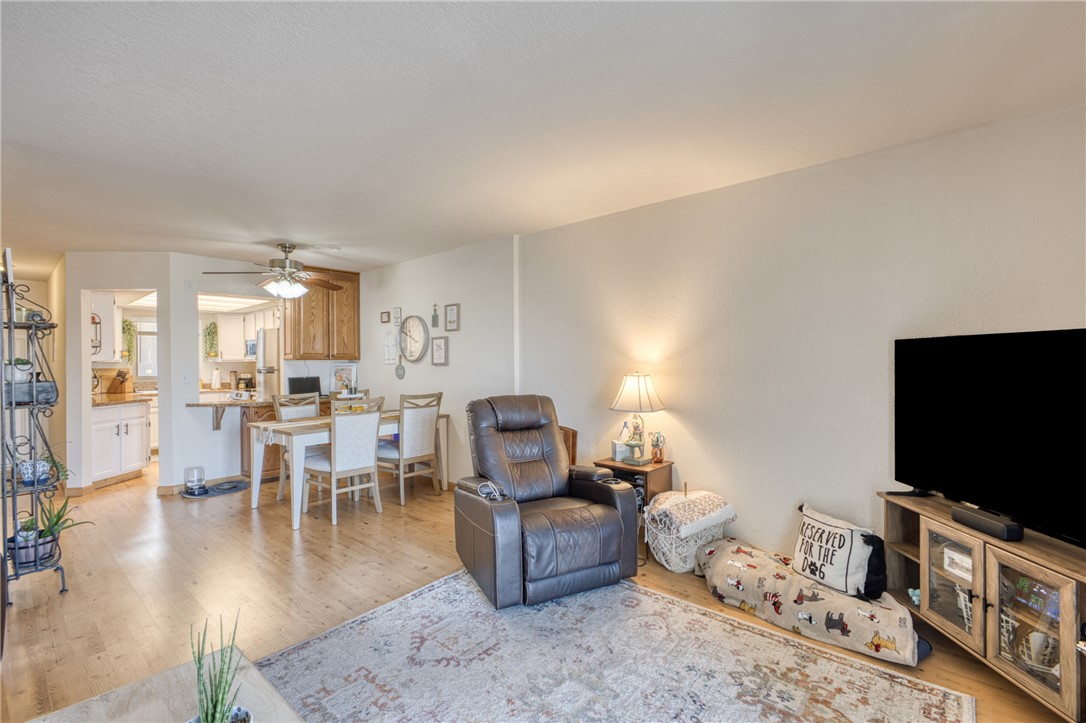 3400 Sunriver Road, Unit D2 Bullhead City, AZ 86429 - Photo 6 of 61 Open concept living area featuring hardwood flooring and a ceiling fan