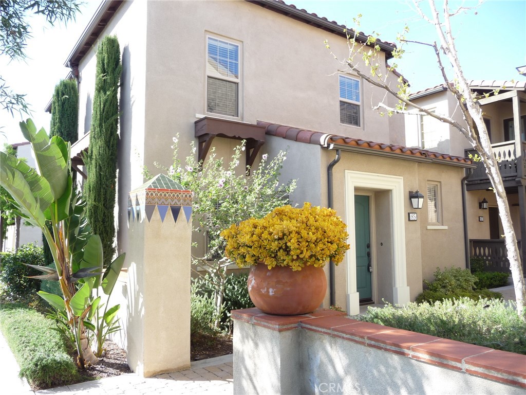 a view of a house with potted plants