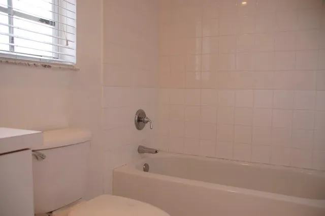 a bathroom with a bathtub and a window