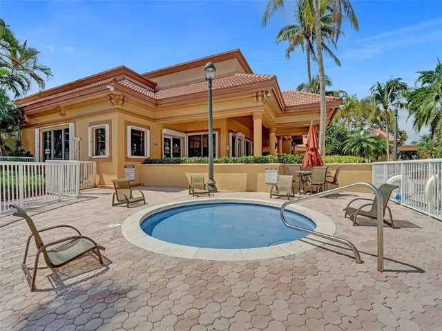 a view of a house with swimming pool and sitting area