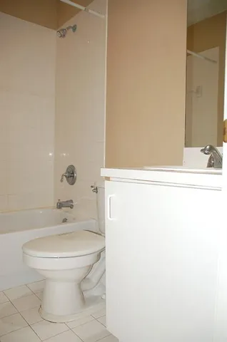 a white toilet sitting next to a bathroom sink