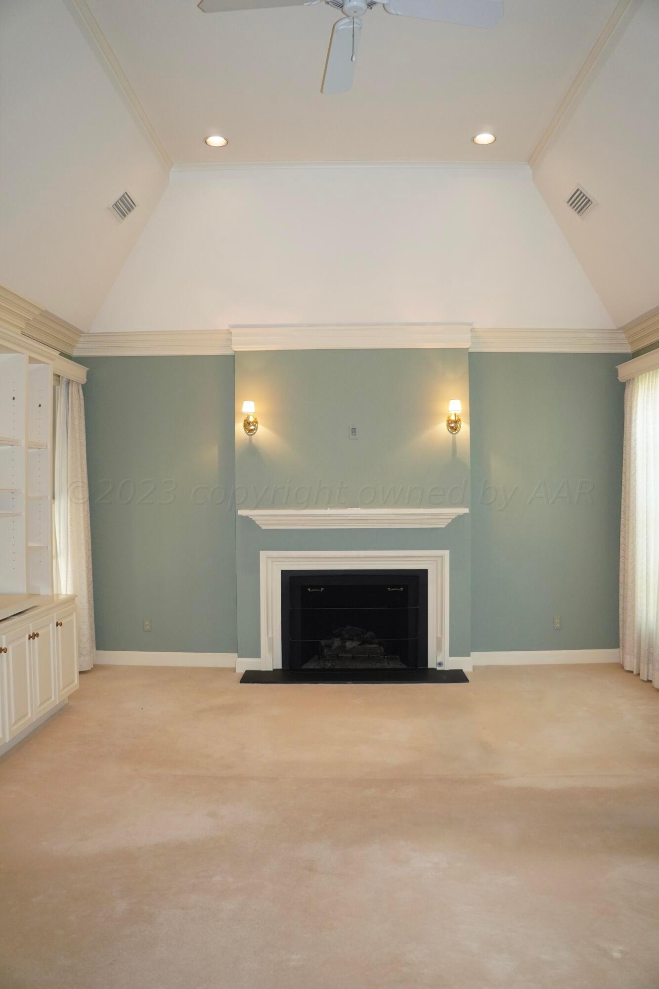 22 Edgewater Drive Amarillo, TX 79106 - Photo 30 of 52 an empty room with a fireplace and window