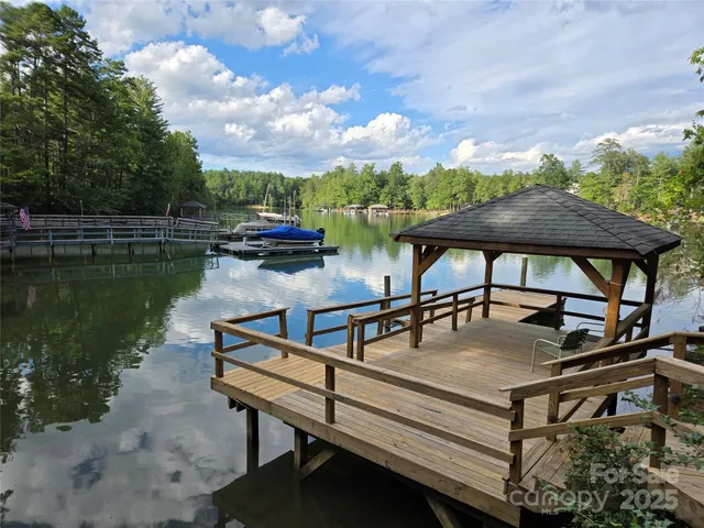 a view of a roof deck with table and chairs a fire pit