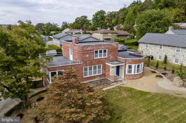 an aerial view of multiple houses with a yard