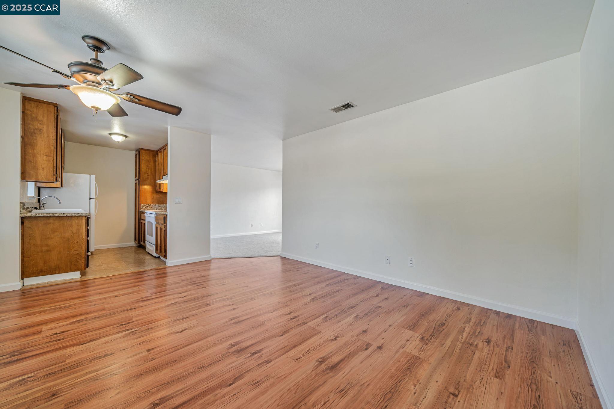 68 Peters Avenue, Unit 6 Pleasanton, CA 94566 - Photo 13 of 40 a view of empty room with wooden floor