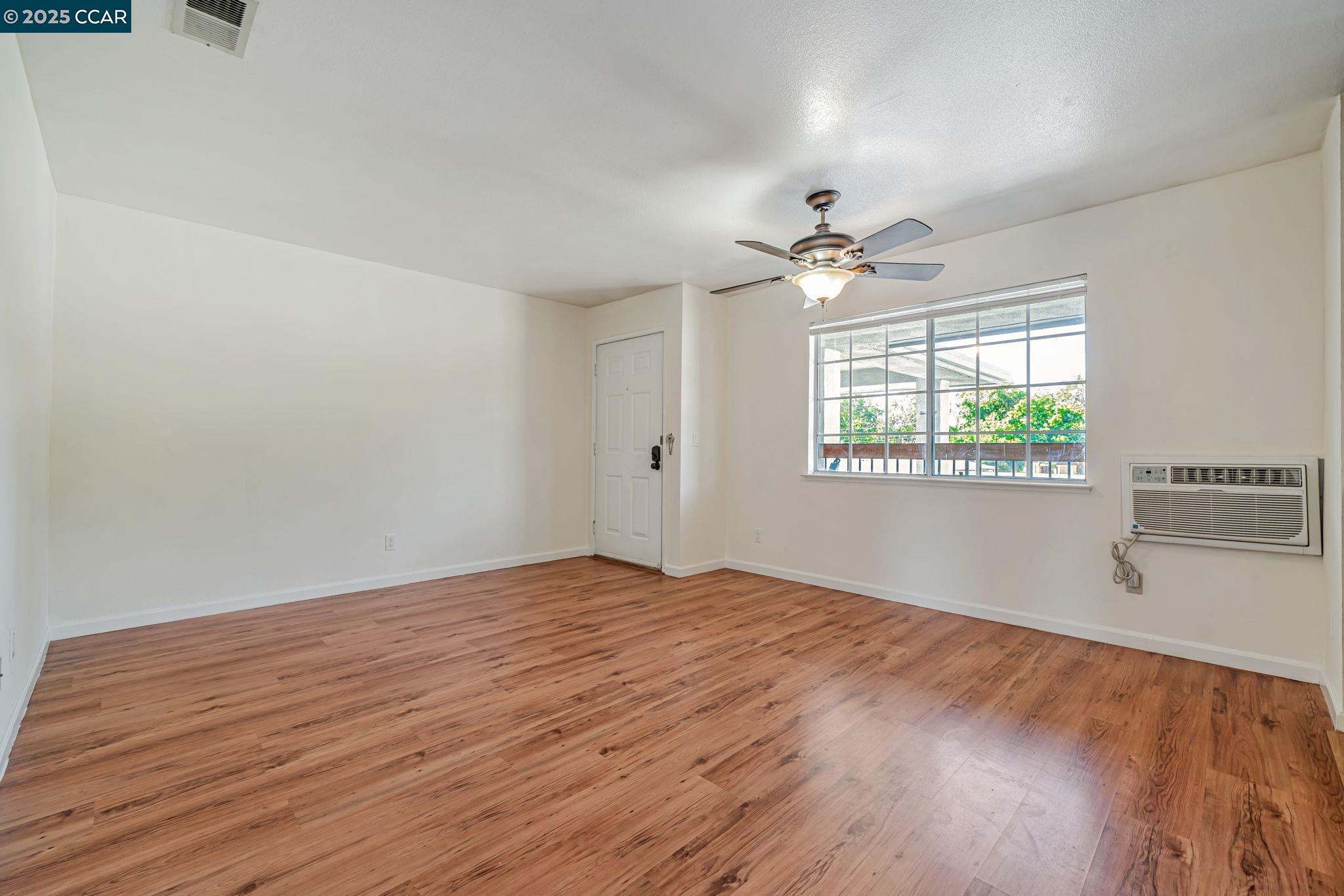 68 Peters Avenue, Unit 6 Pleasanton, CA 94566 - Photo 14 of 40 wooden floor in an empty room with a window
