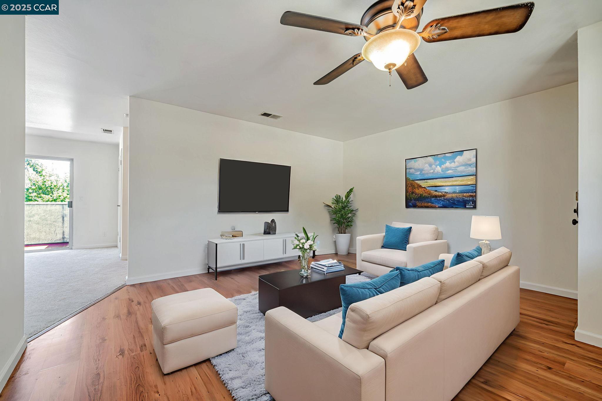 68 Peters Avenue, Unit 6 Pleasanton, CA 94566 - Photo 8 of 40 a living room with furniture and a flat screen tv