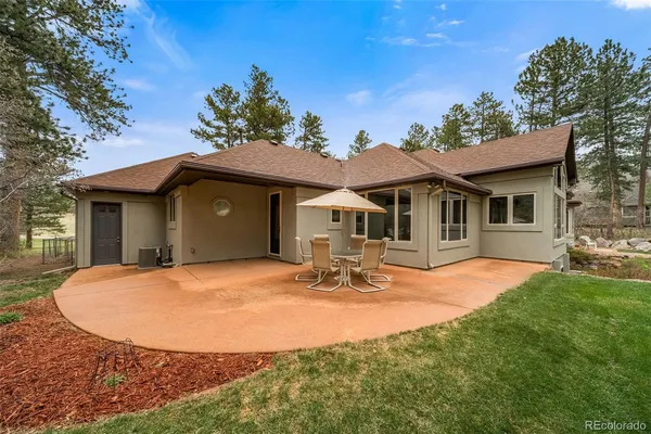a view of a house with backyard porch and sitting area