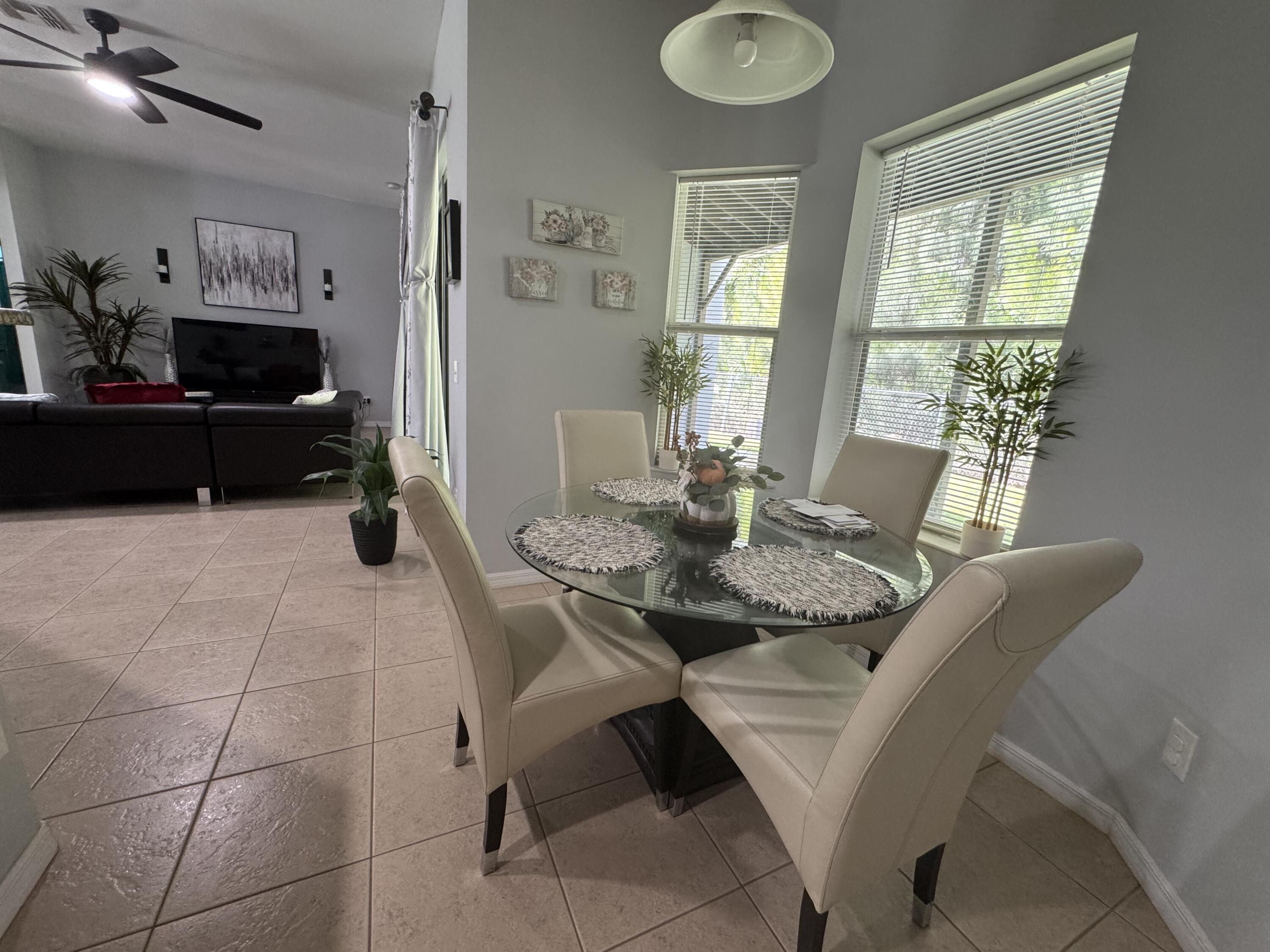 315 Kaye Street Fort Pierce, FL 34947 - Photo 17 of 66 a view of a dining room with furniture and a window