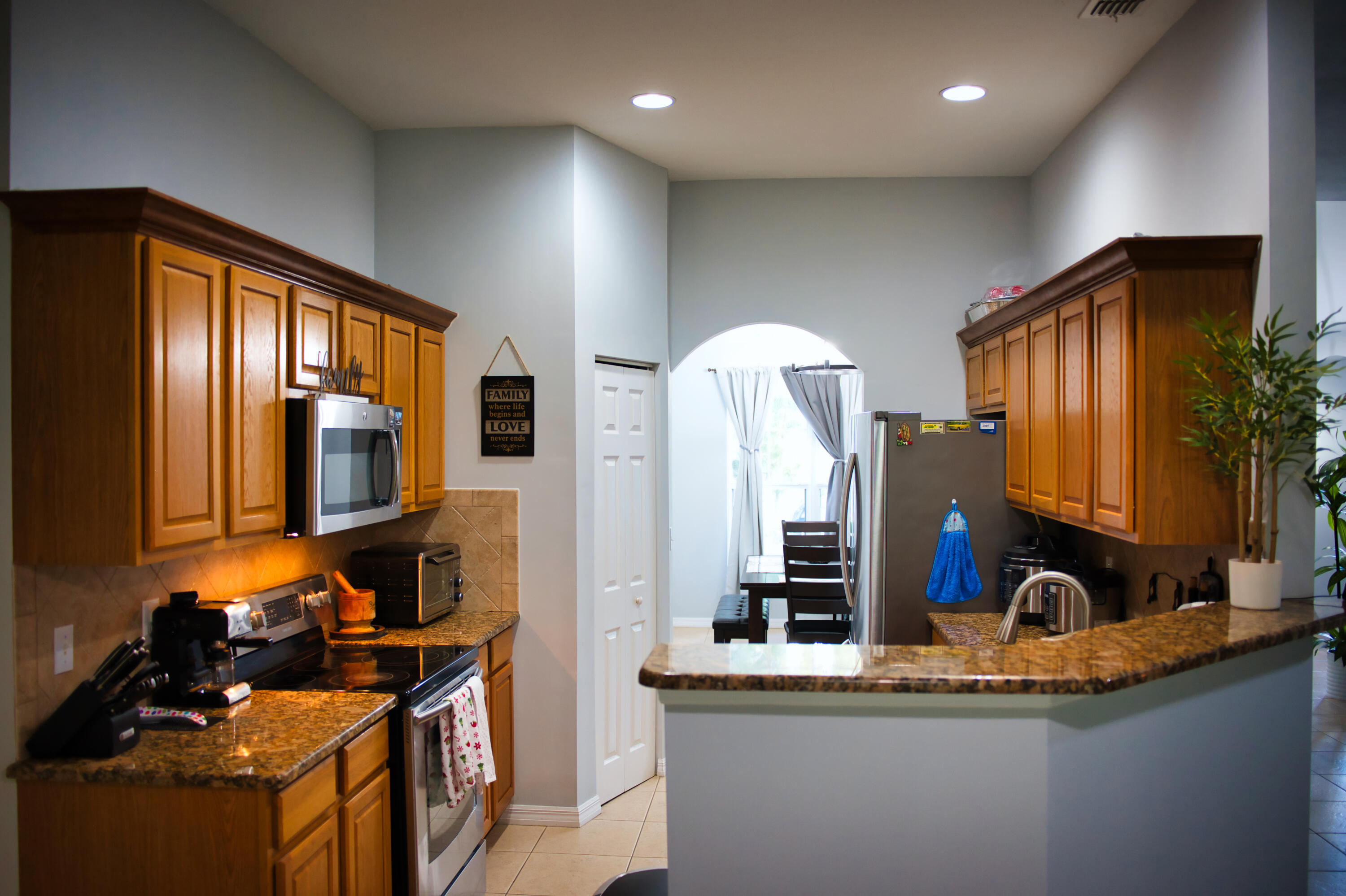 315 Kaye Street Fort Pierce, FL 34947 - Photo 25 of 66 a kitchen with stainless steel appliances granite countertop a sink stove and cabinets