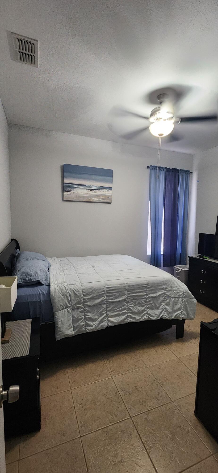 315 Kaye Street Fort Pierce, FL 34947 - Photo 55 of 66 a bedroom with bed and window