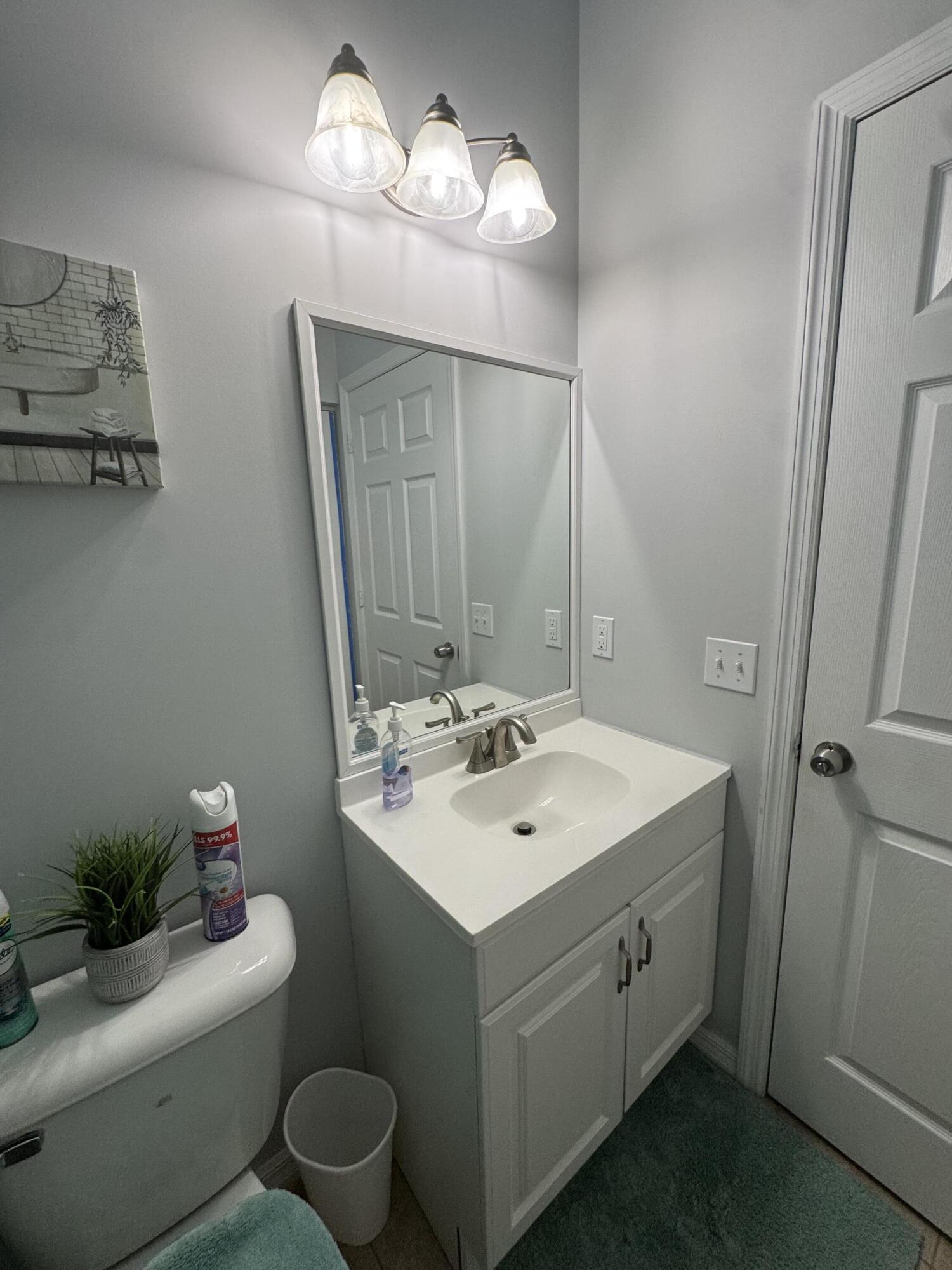 315 Kaye Street Fort Pierce, FL 34947 - Photo 58 of 66 a bathroom with a sink toilet and a mirror